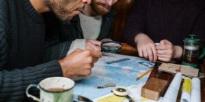 A map and coffee on a table, symbolizing the planning of a local family staycation.