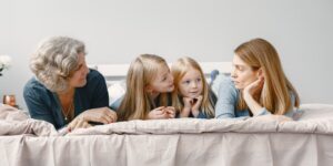 Three generations of a family planning a trip together using a map in a historic town.