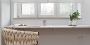 A serene and modern home office setup with neutral colors and natural light.