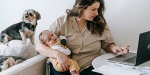 A remote-working parent managing professional tasks in a family-oriented home environment.