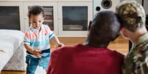 A parent and toddler exploring emotional intelligence with a visual chart in a cozy home environment.