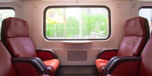 A modern train traveling through a scenic landscape representing the Weekend-Rail strategy.