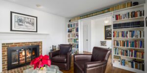A cozy, modern living room setting prepared for a book club meeting with books and coffee.