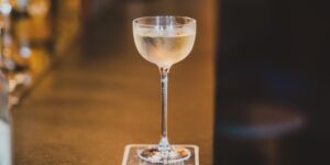 A sophisticated zero-proof cocktail in a crystal glass on a home bar counter.