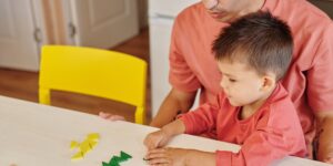 Parent and child engaged in calm, focused play together on a living room floor.