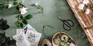 A rustic wooden table filled with garden seeds in packets and jars, representing a community seed swap.
