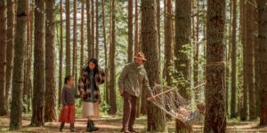 A family enjoying a slow-adventure hike on a gentle forest path.