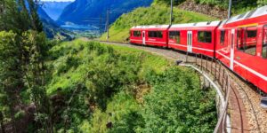 Modern train traveling through the scenic Swiss Alps.