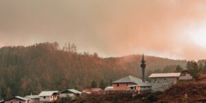 A peaceful rural village landscape at sunset symbolizing quiet tourism.