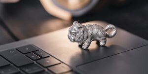 A laptop and a toy on a desk representing the balance between work and life.