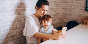 A parent and child navigating digital privacy settings on a tablet in a modern home environment.