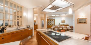 A bright, organized community kitchen library with various appliances on shelves.