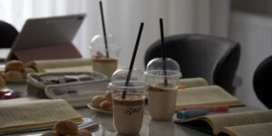 A cozy, minimalist setting for a book club meeting with coffee and books.