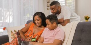 A family using modern technology in a bright living room, symbolizing the future of household electronics.