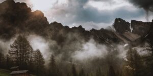 A serene, minimalist cabin in a misty mountain forest, representing a quiet tourism retreat.
