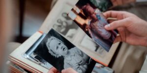 Children exploring family history with an old photo album.