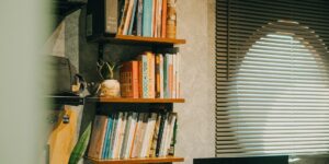 A brightly lit community library shelf stocked with various kitchen appliances.