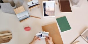 A cozy, organized workspace with digital and physical photo storage devices.