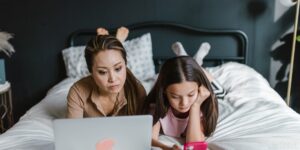 A parent and child peacefully transitioning away from digital screen time together.