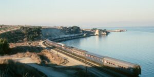 A scenic coastal train journey during golden hour.