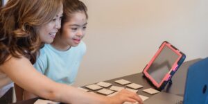 Parent and child engaged in an emotional learning activity at home.