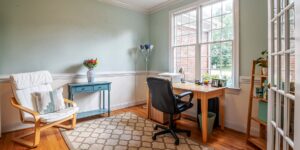 A clean, organized home office space bathed in soft natural light.