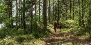 A family hiking together on a local forest trail during a bio-regional trip.