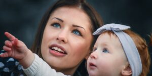 Parent and child looking at an emotional development chart at a kitchen table.