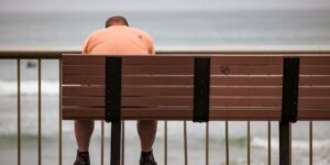 A person taking a quiet moment of reflection on a porch, symbolizing a career break.