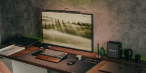 A modern, organized home office setup featuring a laptop and a mesh Wi-Fi node.