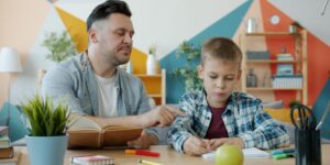 A parent and child engaged in a focused, calm activity together in a bright, cozy living room.