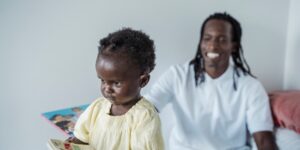 Parent reading an emotion book with a toddler