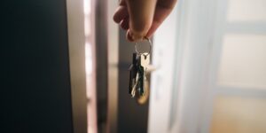 A modern smart lock installed on a rental property door.