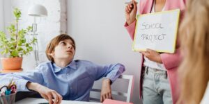Parent and teenager engaged in a calm, collaborative discussion at a home table.