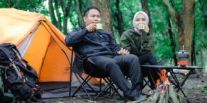 A family enjoying a quiet, minimalist camping experience in a forest.