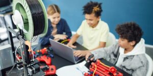 Pre-teens collaborating on a science project in a modern classroom setting.