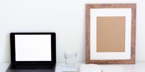 A minimalist home office setup with a family planner tablet and coffee, representing organized family life.