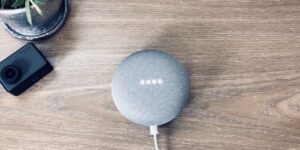 A modern smart home hub on a wooden desk representing local edge computing.