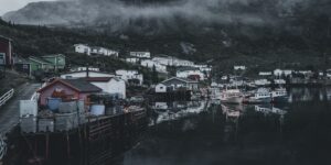 A quiet, misty winter coastal village landscape.