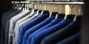 A sophisticated, well-organized professional closet with a mix of high-quality garments.