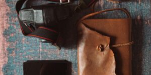 A vintage journal and family photos on a wooden desk for the Ancestral-Roots project.