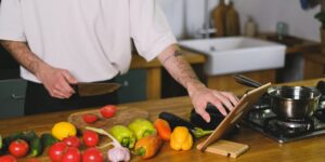 A digital tablet and fresh ingredients on a kitchen counter representing organized meal planning.