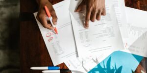 A person reviewing their finances at a desk to perform a subscription audit.