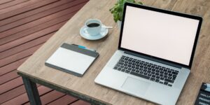 A serene, unplugged workspace setup with a closed laptop and coffee.