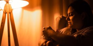A soft, warm-lit nursery at night emphasizing smart lighting for parents.