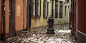 Quiet cobblestone street in a historic city during off-peak season.