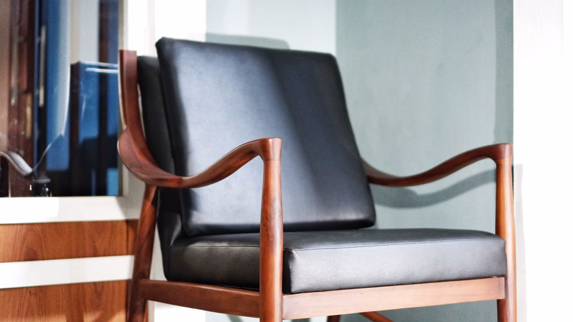 A close-up of a premium, pre-owned wooden high chair.
