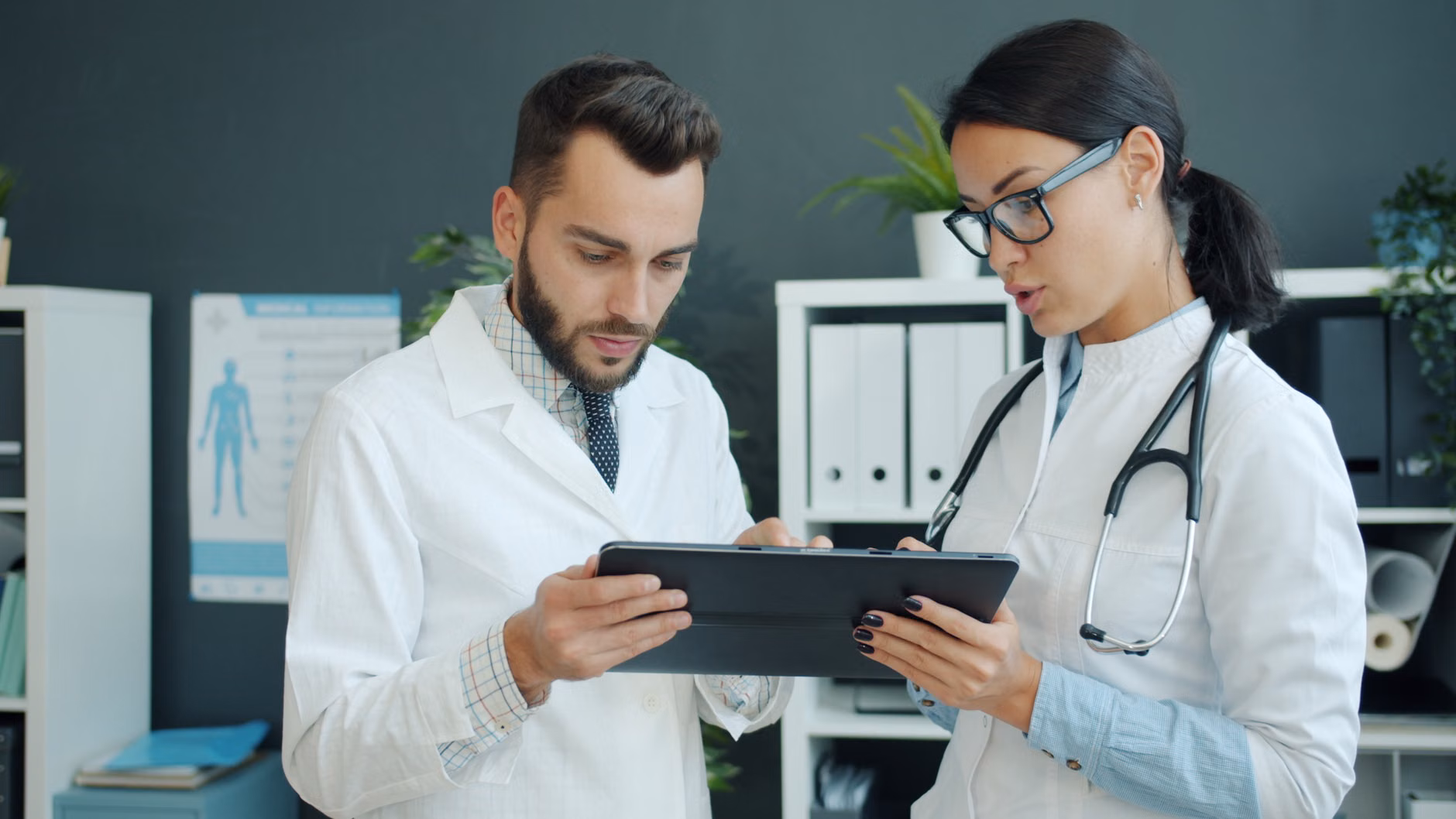 A parent reviewing family health data on a tablet.