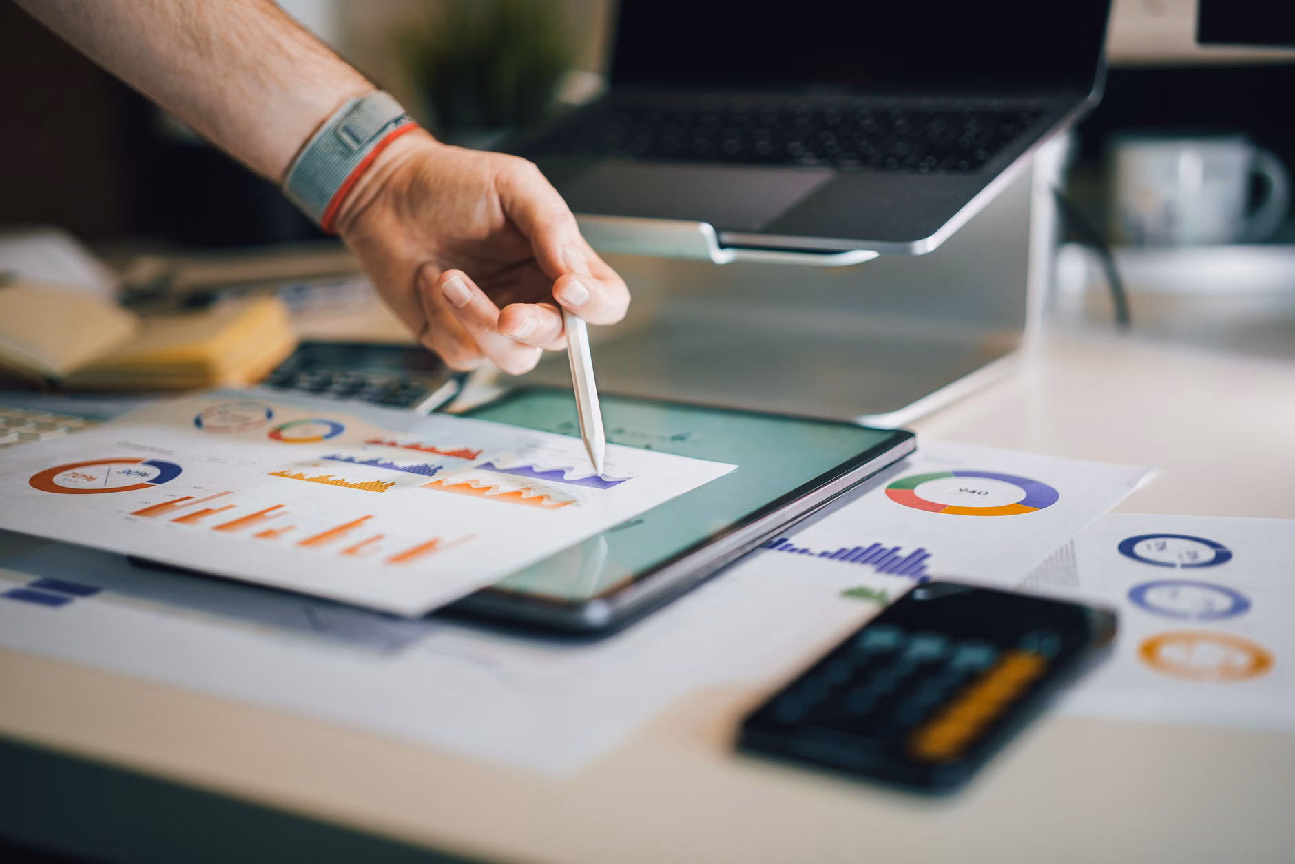 Person auditing digital subscription expenses on a tablet.