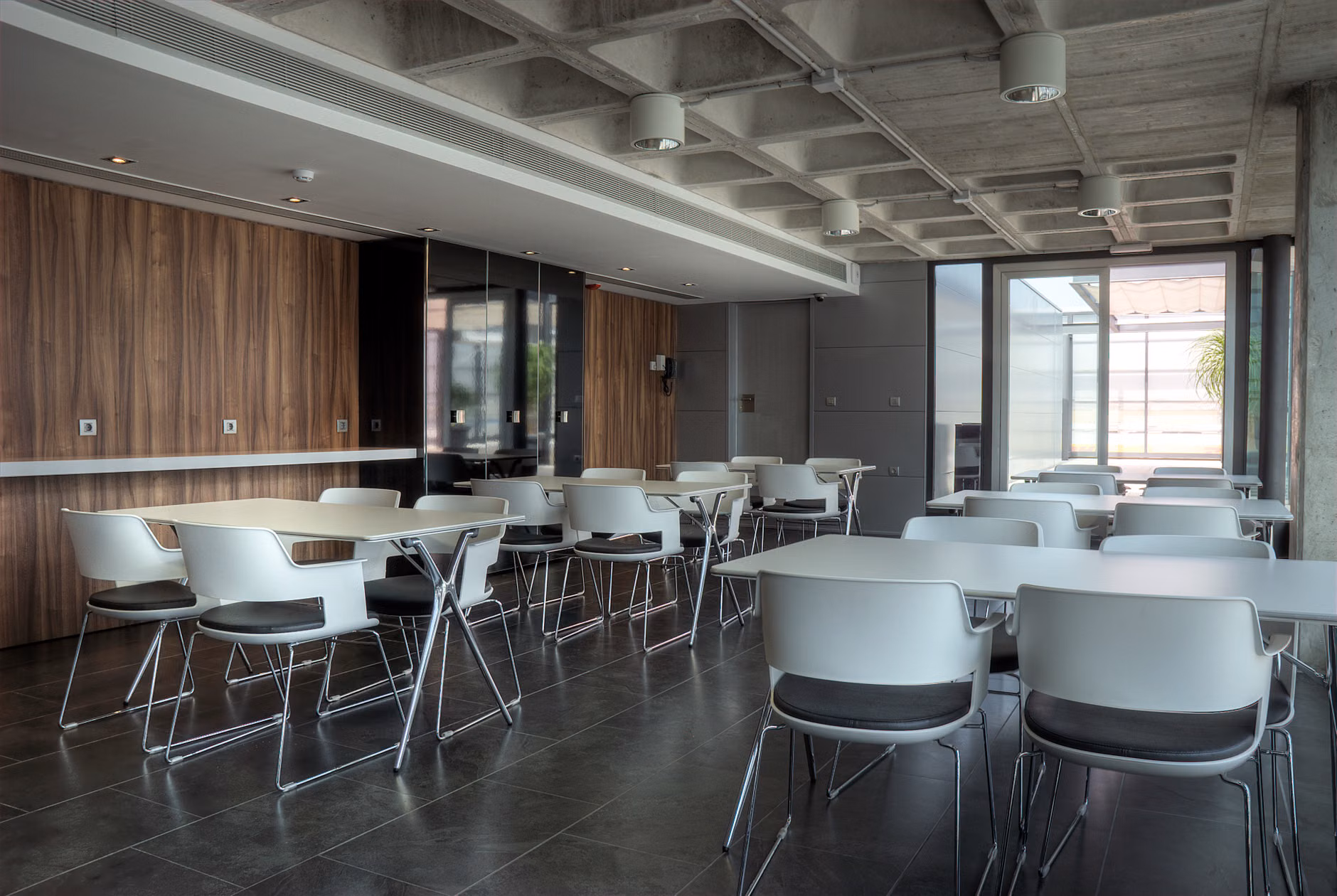 Cafeteria seating pods designed for privacy and reduced visual clutter.